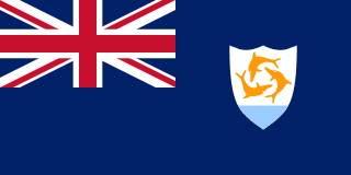 The flag of Anguilla is blue, with the flag of the UK in the canton and the national coat of arms centered in the fly half. The coat of arms depicts three orange dolphins in an interlocking circular design on a white background with a turquoise-blue field below.