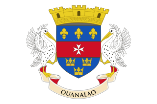 The flag of Saint Barthélemy features the national coat of arms centered on a white field. The coat of arms is a shield divided into three horizontal stripes: three gold fleurs-de-lis on blue, above a white Maltese cross on red, over three gold crowns on blue. Below the shield is a banner with "OUANALAO," which is what the indigenous people called the island. On top of the shield is a mural crown.