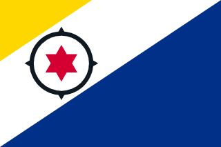 The flag of the Caribbean Netherlands features a large blue triangle at the lower fly-side corner, spanning half the flag, and a smaller yellow triangle at the opposite corner, separated by a white strip containing a black compass surrounding a red six-pointed star.