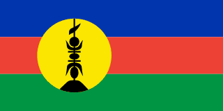 The flag of New Caledonia has three equal horizontal bands of blue, red, and green. A large yellow disk shifted slightly to the hoist side displays a black symbol of a native rooftop adornment.