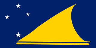 The flag of Tokelau features a yellow stylized canoe on a dark blue field sailing toward the Southern Cross constellation with four white five-pointed stars at the hoist side.